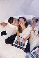 couple using tablet and laptop computers top view photo