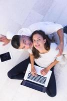 couple using tablet and laptop computers top view photo