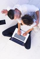 couple using tablet and laptop computers top view photo