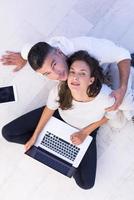 couple using tablet and laptop computers top view photo