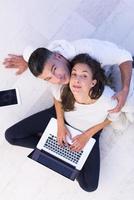 couple using tablet and laptop computers top view photo