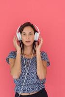 woman with headphones isolated on a red photo