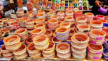A stall selling women's bangles. This bracelet is a great accessory for india women and fans of traditional Indian accessories photo