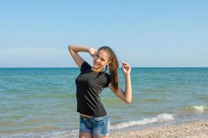 Young cheerful girl on the sea photo