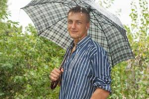 Man with umbrella in rain photo