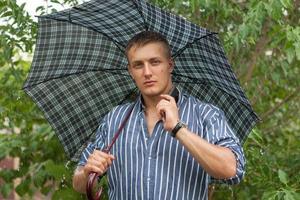Man with umbrella and mobile phone photo