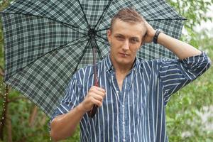 Man with umbrella in rain photo