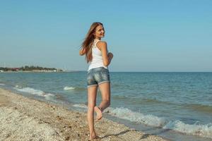 Young cheerful girl on the sea photo
