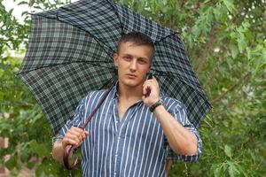 Man with umbrella and mobile phone photo