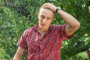 Sexy young man wet in rain photo