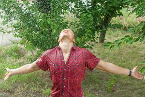 Sexy young man wet in rain photo