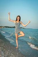 Young cheerful girl on the sea photo