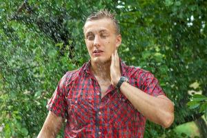 Sexy young man wet in rain photo