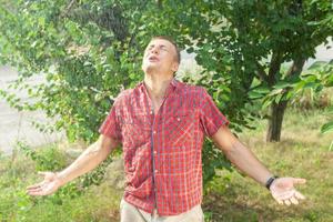 Sexy young man wet in rain photo