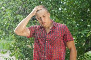 Sexy young man wet in rain photo