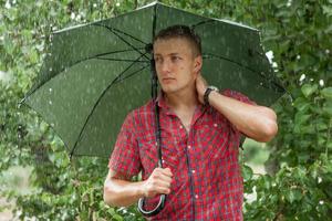 hombre con paraguas bajo la lluvia foto