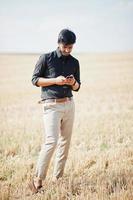 South asian agronomist farmer inspecting wheat field farm. Agriculture production concept. photo