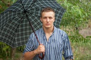 Man with umbrella in rain photo