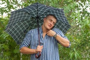 Man with umbrella and mobile phone photo