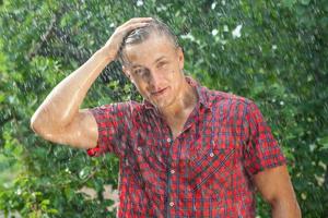 Sexy young man wet in rain photo