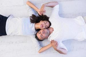 handsome couple lying on floor photo