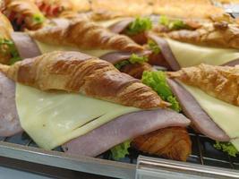 Closeup. Croissant with ham and cheese on tray. photo