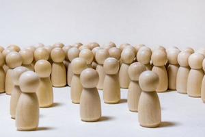 follow the leader or human resource management concept. crowd of wooden people photo