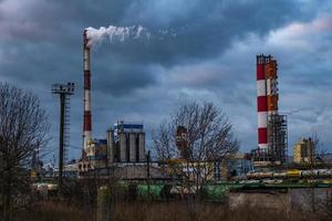 pipes of a chemical enterprise plant. Air pollution concept. Industrial landscape environmental pollution waste of thermal power plant photo