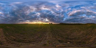 full seamless spherical hdri panorama 360 degrees angle view among fields in summer evening sunset with awesome blue pink red clouds in equirectangular projection, ready for VR AR virtual reality photo