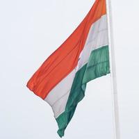 India flag flying high at Connaught Place with pride in blue sky, India flag fluttering, Indian Flag on Independence Day and Republic Day of India, tilt up shot, Waving Indian flag, Har Ghar Tiranga photo