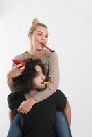 couple in party hats blowing in whistle photo