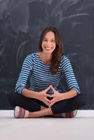 woman sitting in front of chalk drawing board photo