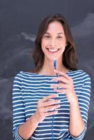 woman holding a internet cable in front of chalk drawing board photo