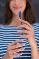 woman holding a internet cable in front of chalk drawing board photo