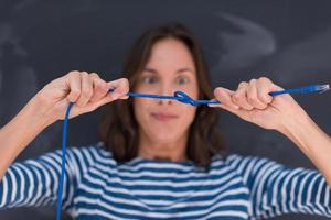 woman holding a internet cable in front of chalk drawing board photo