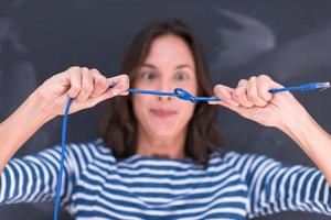 woman holding a internet cable in front of chalk drawing board photo