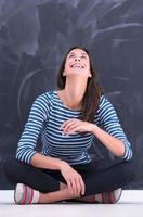 woman sitting in front of chalk drawing board photo