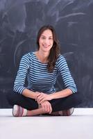 woman sitting in front of chalk drawing board photo