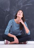 woman sitting in front of chalk drawing board photo