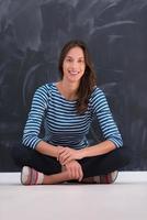 woman sitting in front of chalk drawing board photo