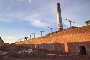 Brickfield View of the Evening Sunlight under the White Cloudy Blue sky photo