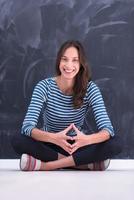 woman sitting in front of chalk drawing board photo