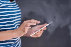 woman using tablet  in front of chalk drawing board photo