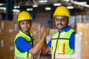Workers man soul brother handshake, thumb clasp handshake or homie handshake with blurred warehouse background, Success and Teamwork concepts photo