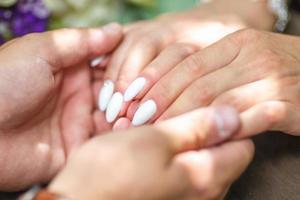 romantic couple holding hands. Lovers or newlywed married young couple in romance. wedding theme photo