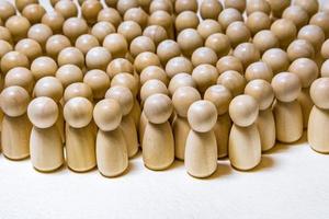 follow the leader or human resource management concept. crowd of wooden people photo