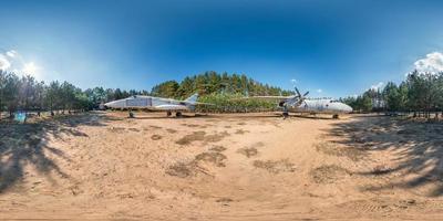 full spherical hdri panorama 360 degrees angle view in forest guerrilla camp with old military transport aircraft and fighter airplane in pinery forest in equirectangular projection. VR AR content photo