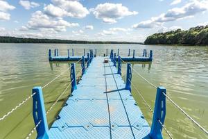 colored plastic pier on the shore of a large lake photo