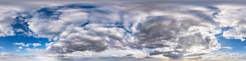 Seamless hdri panorama 360 degrees angle view blue sky with beautiful evening fluffy cumulus clouds without ground with zenith for use in 3d graphics or game development as sky dome or edit drone shot photo