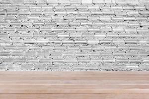 brown wood table top on white concrete wall background - can be used for montage or display your products photo